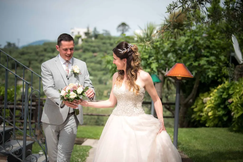 Bride and groom smiling at each other during their garden ceremony near Sorrento