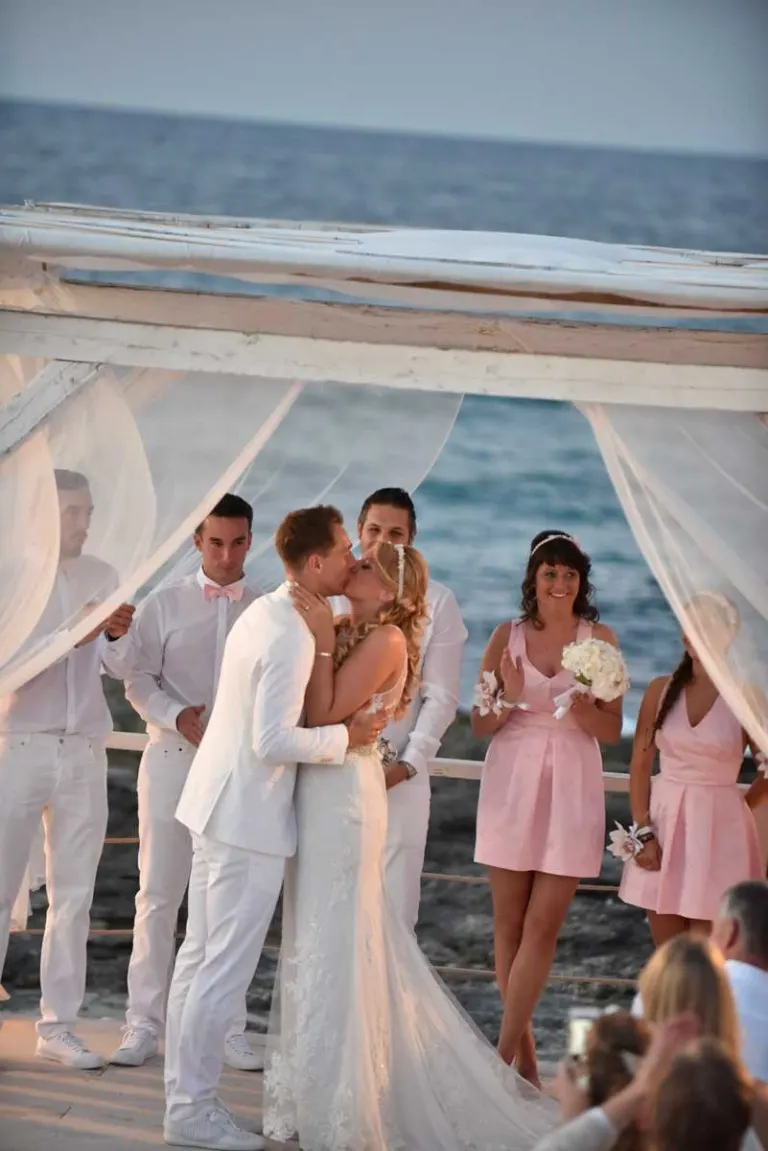 Bride and groom’s kiss at their wedding in Polignano a Mare