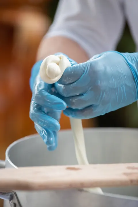 The making of fresh Apulian mozzarella at a wedding in Puglia
