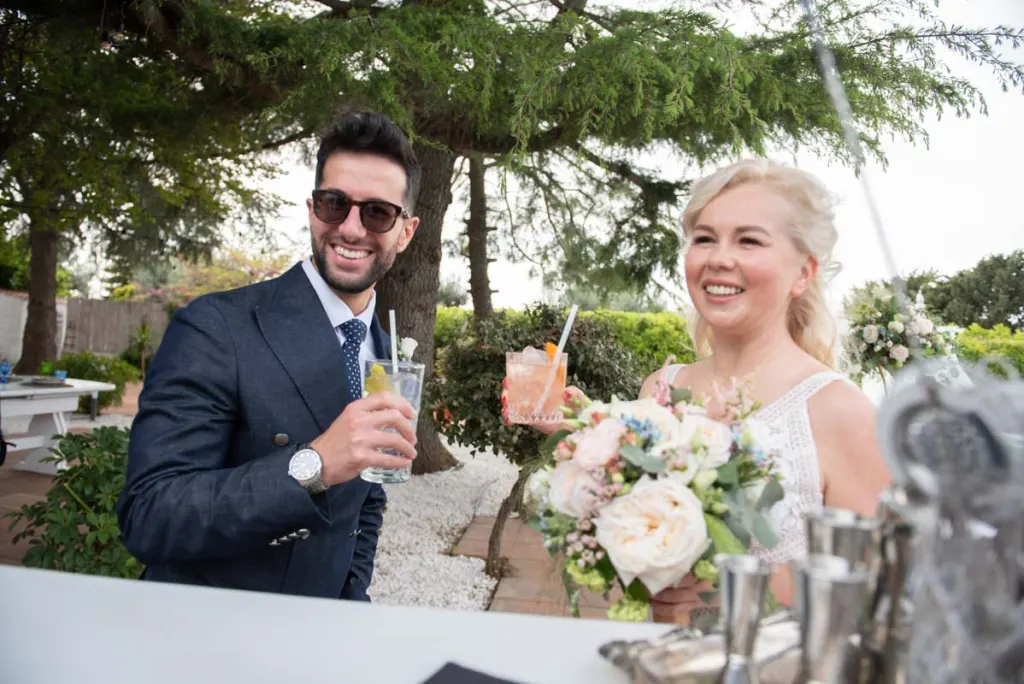 Bride and groom enjoying a drink at the wedding aperitivo in Puglia