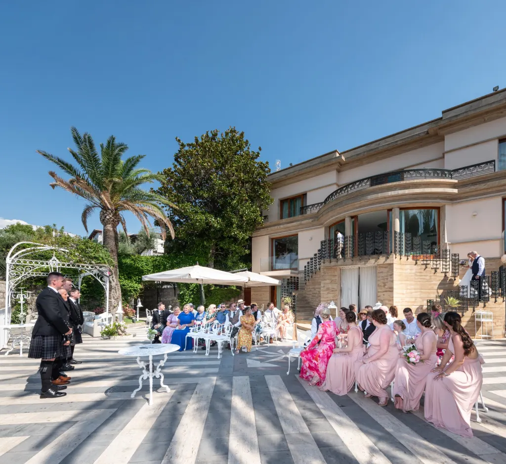 Guests at a wedding ceremony in Sorrento, waiting for the bride