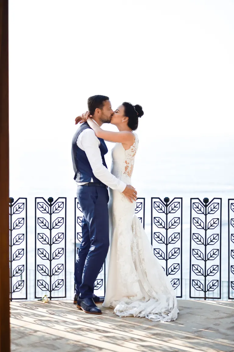 Bride and groom kissing at their wedding in Sorrento