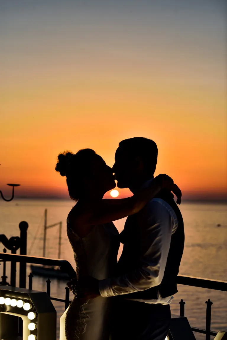 Bride and groom kissing at sunset in Sorrento